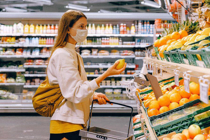 a young woman in grocery buying limon